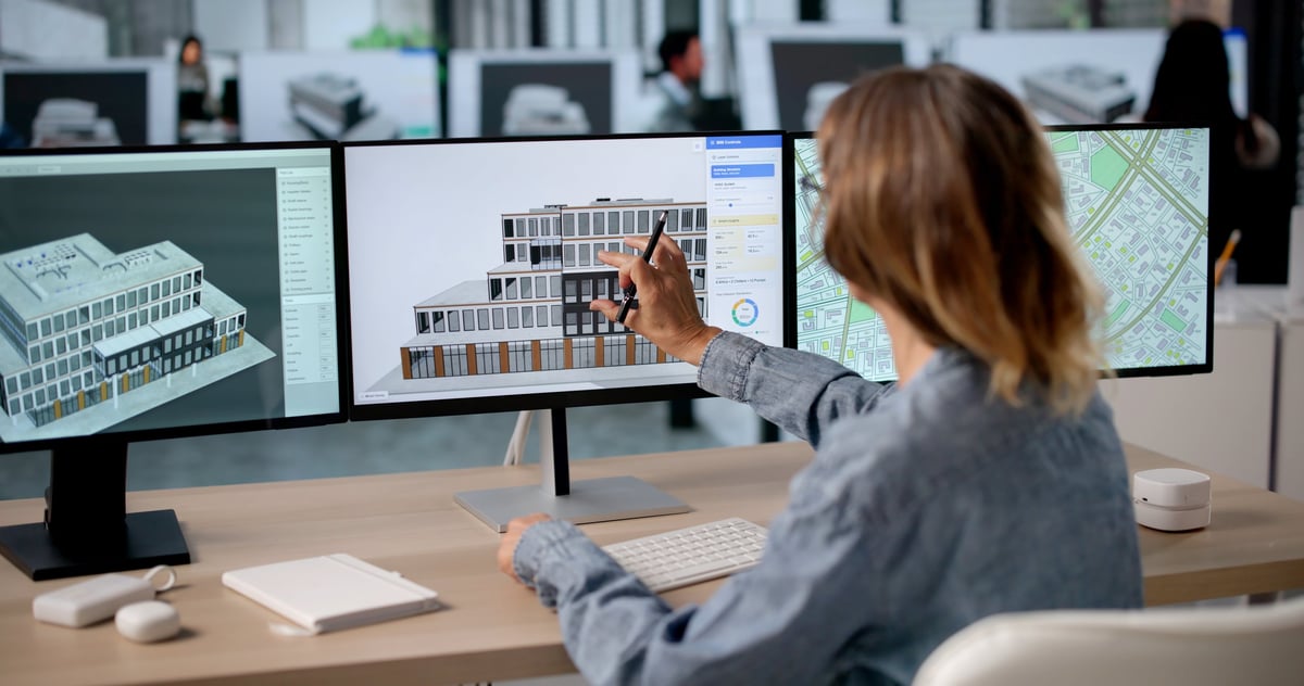 Engineer reviewing electrical design on multiple monitors
