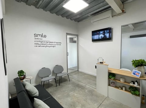 Modern office waiting area with smile wall art