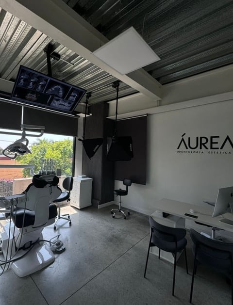 Modern dental office interior with AUREA signage and dental chair